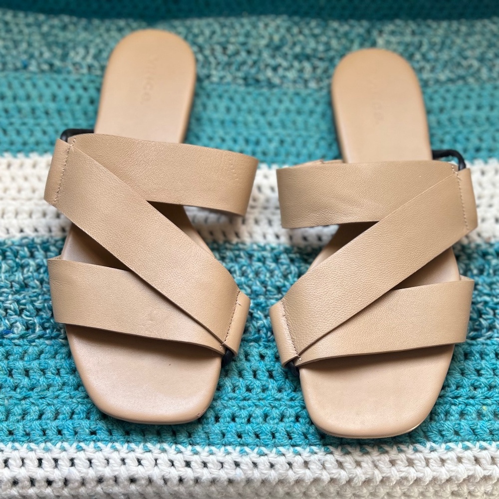 Vince Dylan slide sandal. Tan leather criss cross upper with black trim.